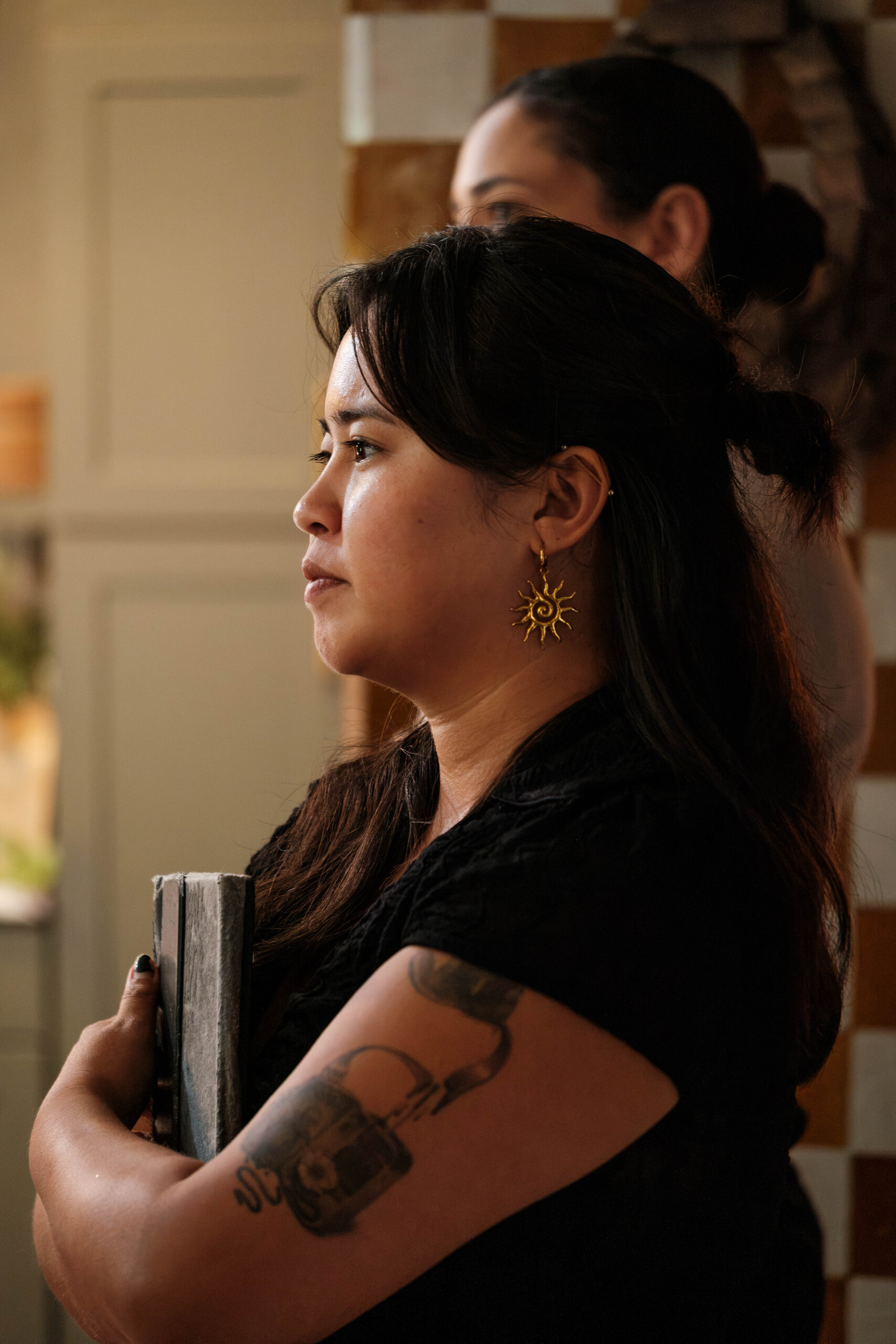 A crew member waits in profile with the slate.