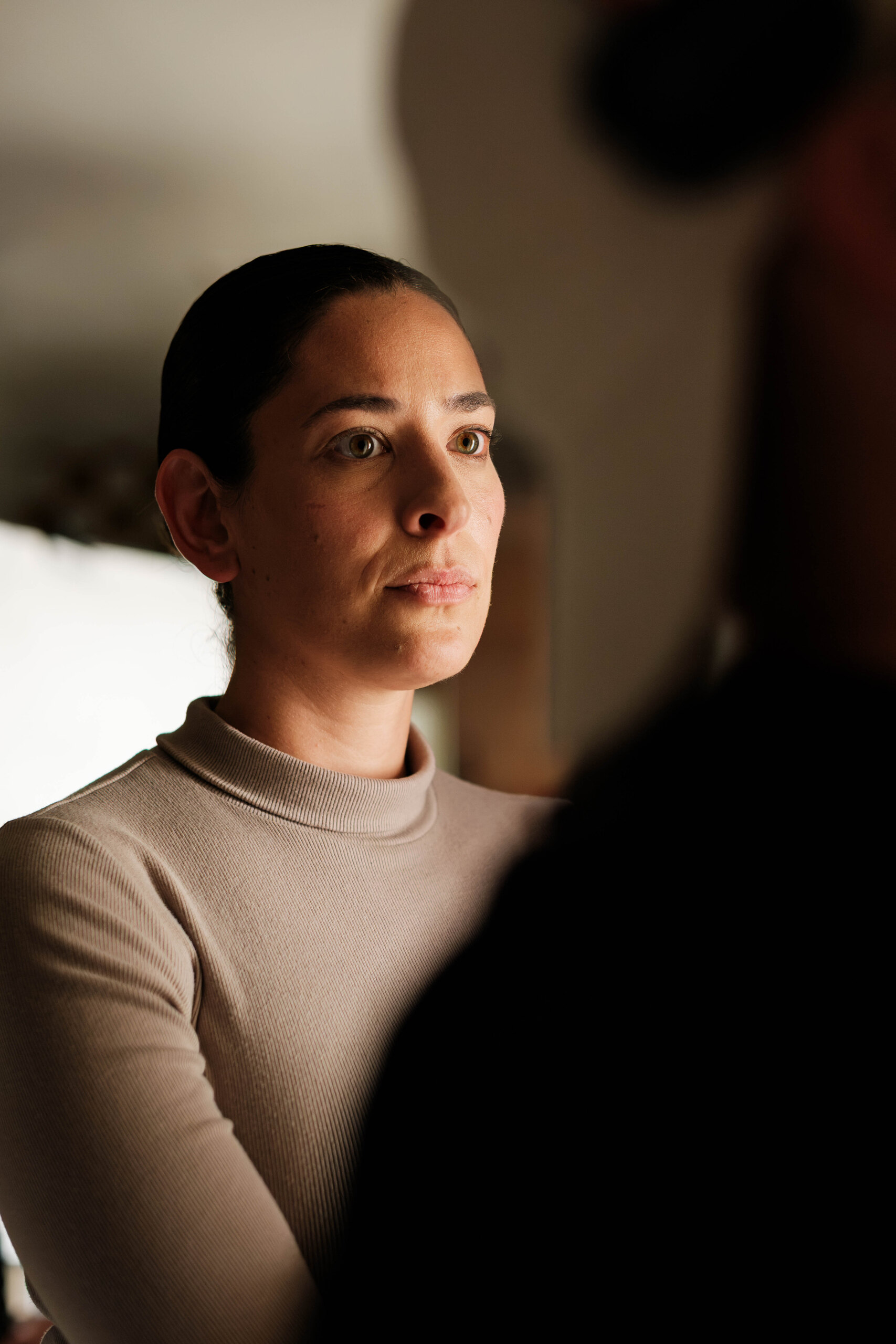 Rebecca Milligan in character, looking off past the camera.